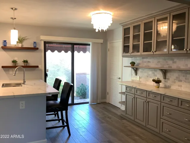 a kitchen with sink cabinets and dining table