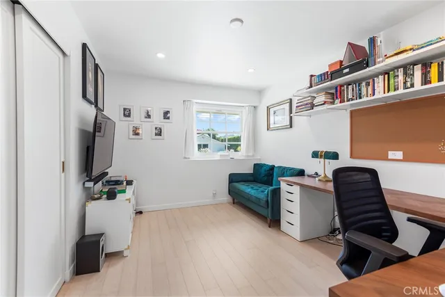 a bedroom with furniture and a book shelf
