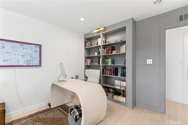 a bedroom with a bed and a book shelf