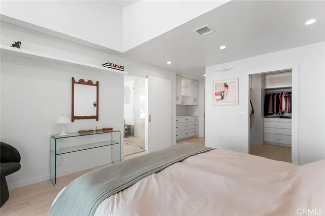 a bedroom with a bed and a couch