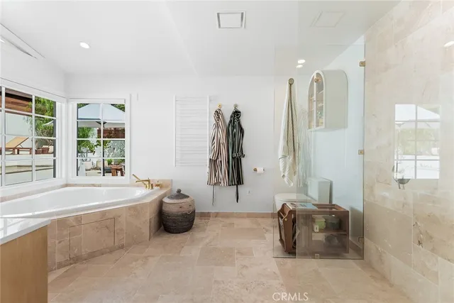 a spacious bathroom with a tub and a shower