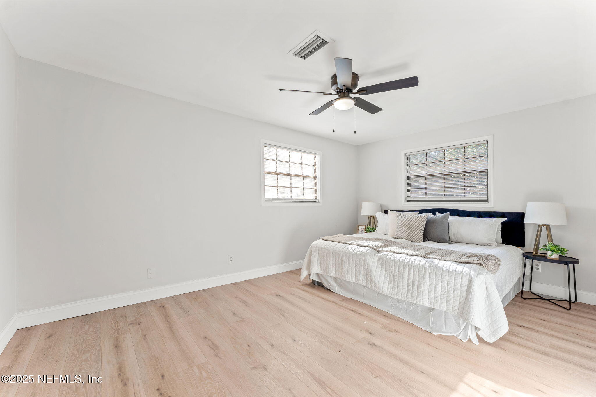 6211 Firestone Road Jacksonville, FL 32244 - Photo 18 of 41 a bedroom with a bed ceiling fan and a window