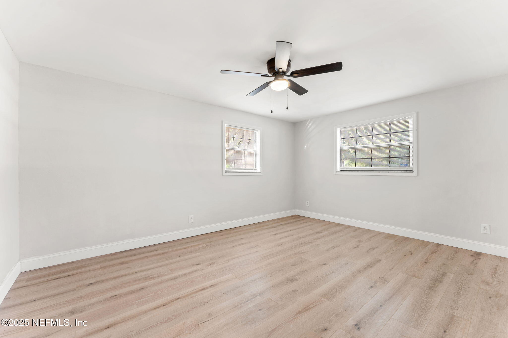 6211 Firestone Road Jacksonville, FL 32244 - Photo 20 of 41 a view of a big room with wooden floor and windows