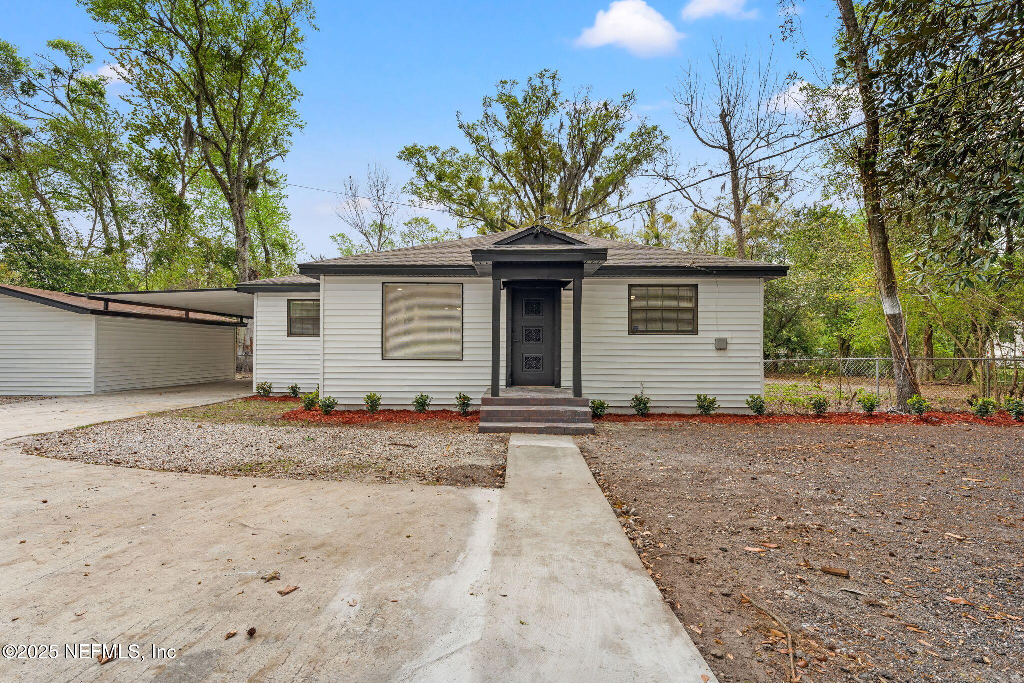 6211 Firestone Road Jacksonville, FL 32244 - Photo 2 of 41 a front view of a house with a yard and garage