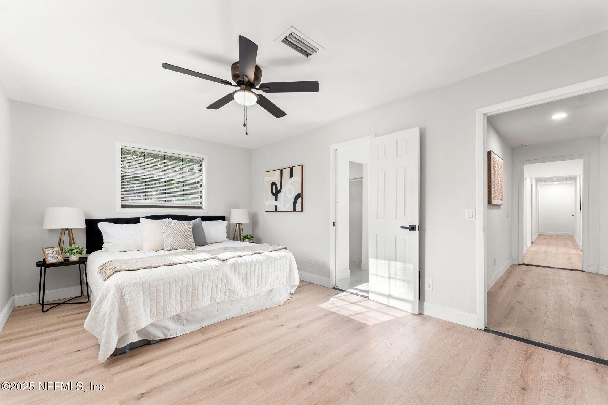 6211 Firestone Road Jacksonville, FL 32244 - Photo 22 of 41 a bedroom with a large bed and a chandelier