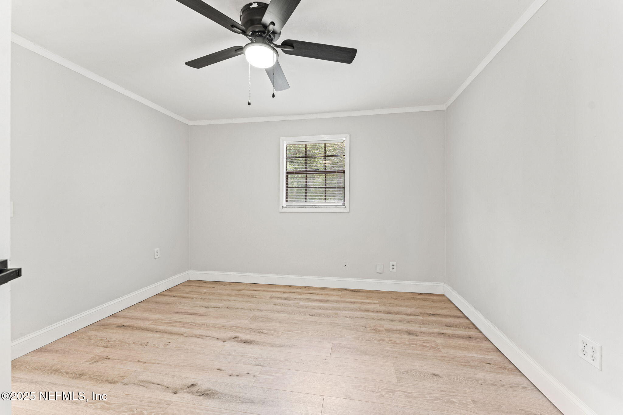 6211 Firestone Road Jacksonville, FL 32244 - Photo 24 of 41 an empty room with a window and a fan