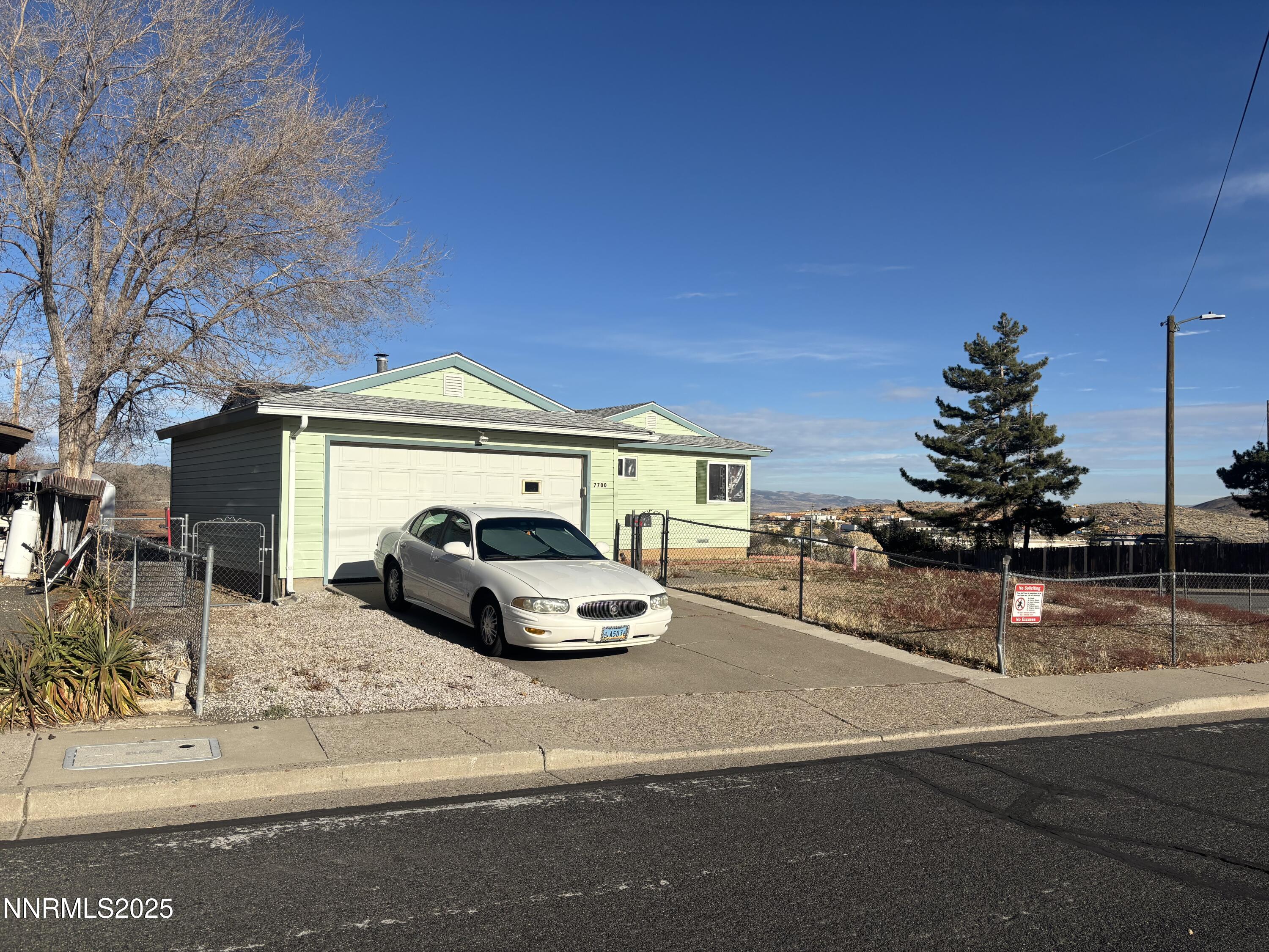 7700 Essex Way Reno, NV 89506 - Photo 1 of 4 a car parked in front of a house