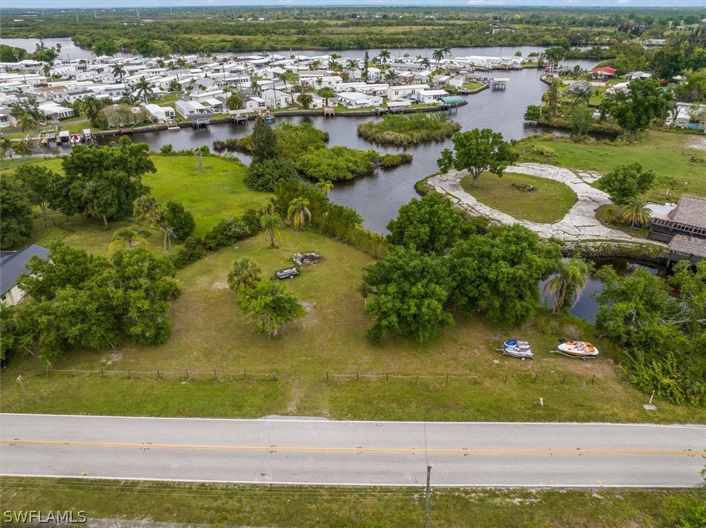 an aerial view of residential houses with outdoor space and swimming pool