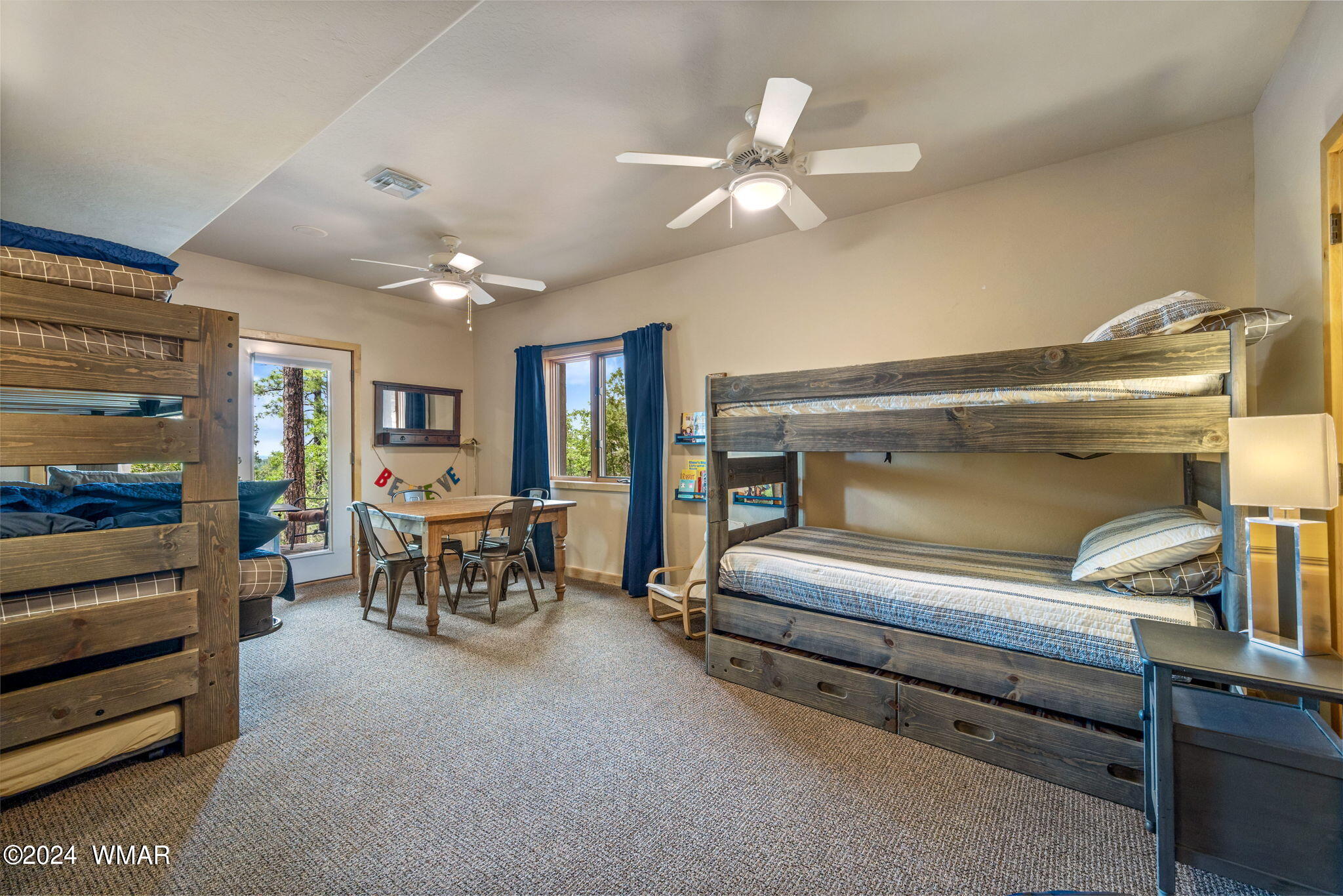 3361 West Falling Leaf Road Show Low, AZ 85901 - Photo 20 of 49 This kids' bunk room is a delightful space with doors leading directly to the deck, offering easy access to outdoor play. With ample room for fun and games, it?s the perfect retreat for children to enjoy and make lasting memories.