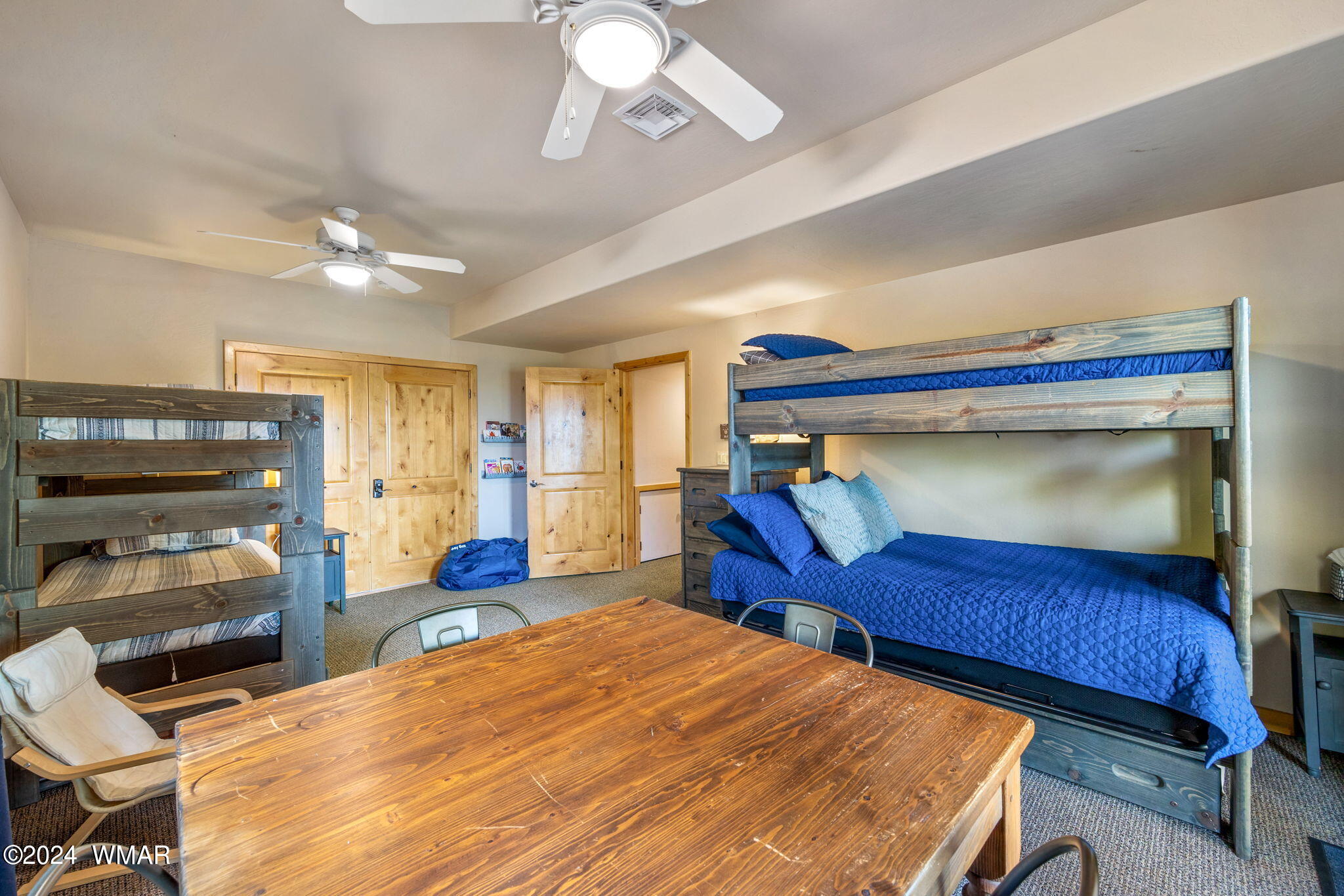 3361 West Falling Leaf Road Show Low, AZ 85901 - Photo 21 of 49 This kids' bunk room is a delightful space with doors leading directly to the deck, offering easy access to outdoor play. With ample room for fun and games, it?s the perfect retreat for children to enjoy and make lasting memories.