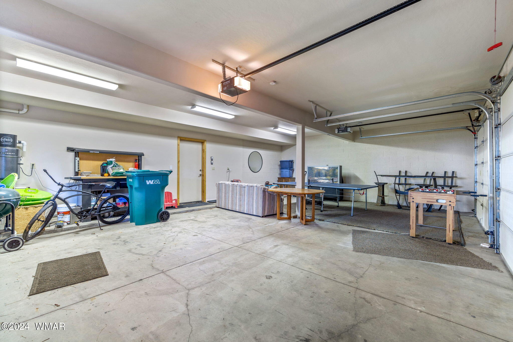 3361 West Falling Leaf Road Show Low, AZ 85901 - Photo 26 of 49 3 car garage with EV outlet, ping pong table, Foosball table, TV and couch. perfect for the kids to play