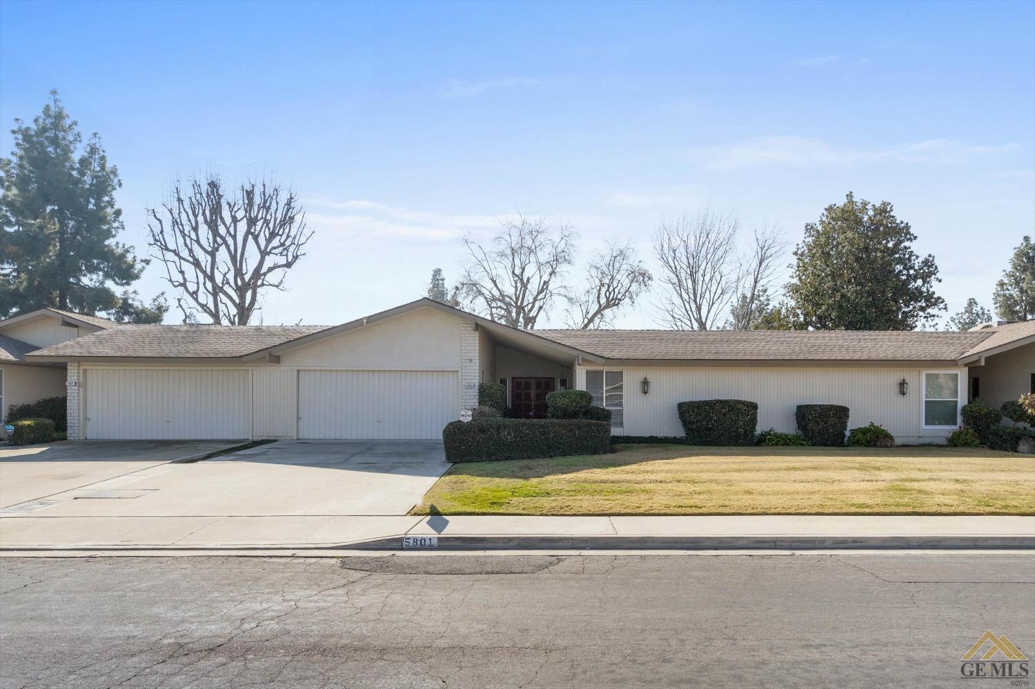 a view of a house with a swimming pool and a yard
