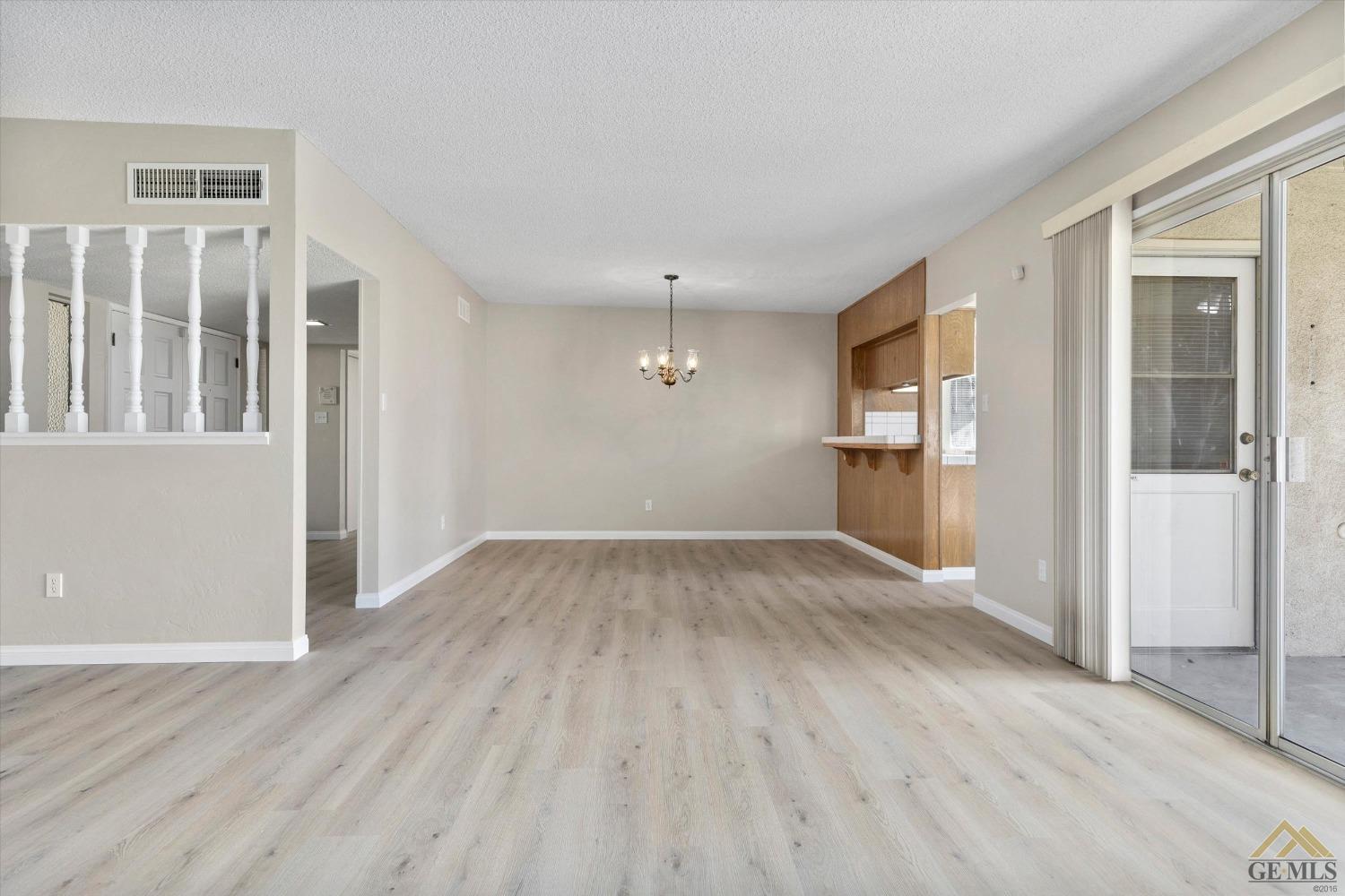 Undisclosed Address Bakersfield, CA 93309 - Photo 11 of 32 an empty room with wooden floor and windows