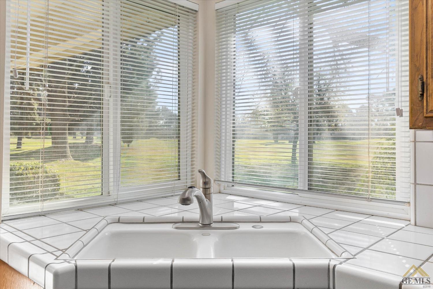 Undisclosed Address Bakersfield, CA 93309 - Photo 19 of 32 a bathroom with a granite countertop sink and a window