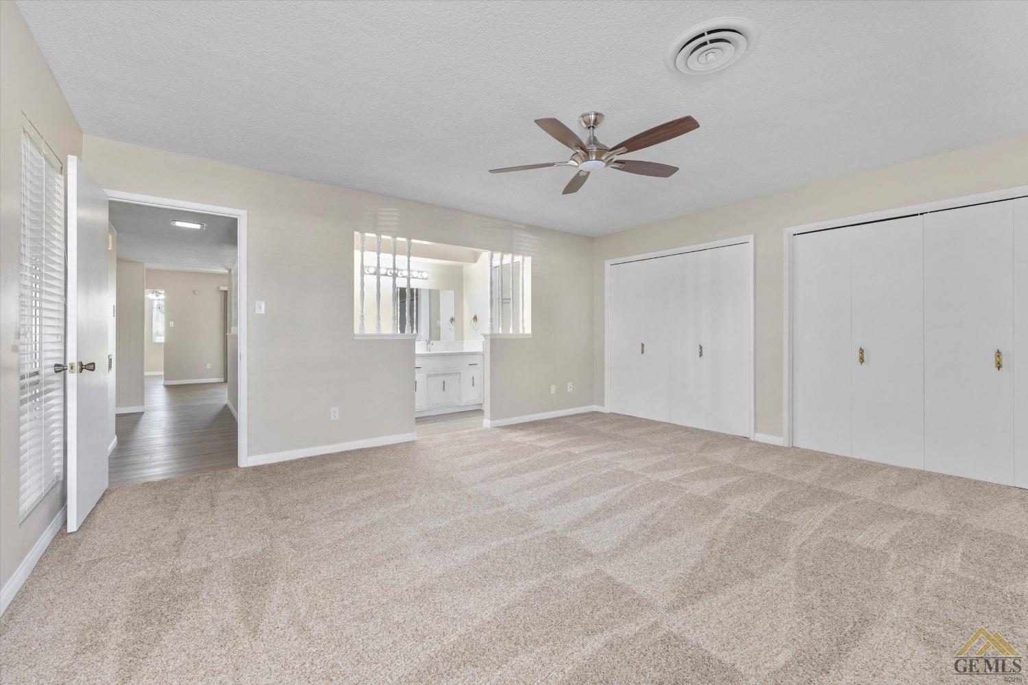 Undisclosed Address Bakersfield, CA 93309 - Photo 21 of 32 a view of a livingroom with a ceiling fan & windows