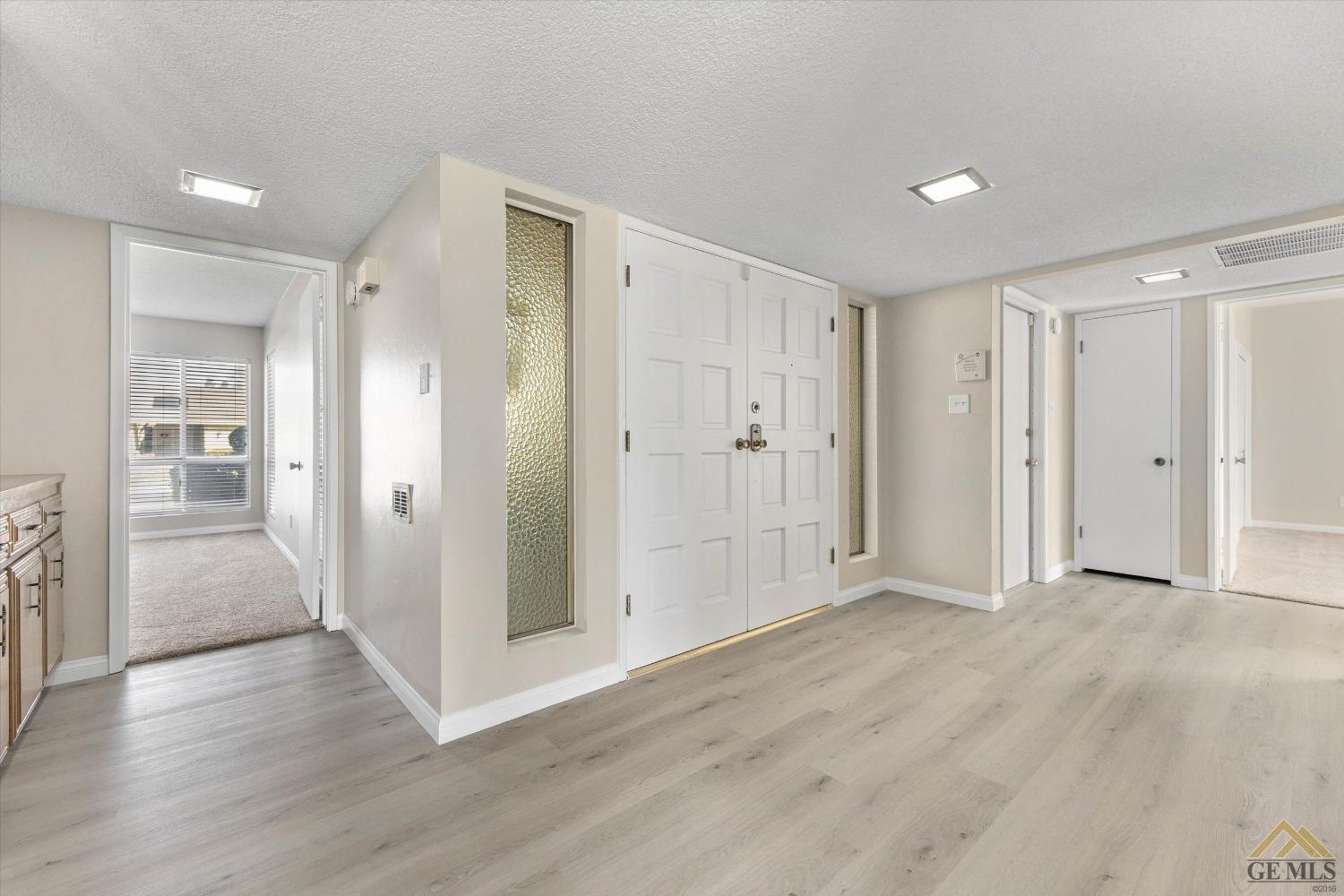 Undisclosed Address Bakersfield, CA 93309 - Photo 5 of 32 a view of an empty room with wooden floor and a bathroom