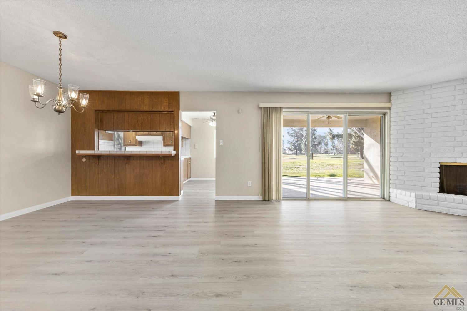 Undisclosed Address Bakersfield, CA 93309 - Photo 6 of 32 a view of an empty room with a window and wooden floor