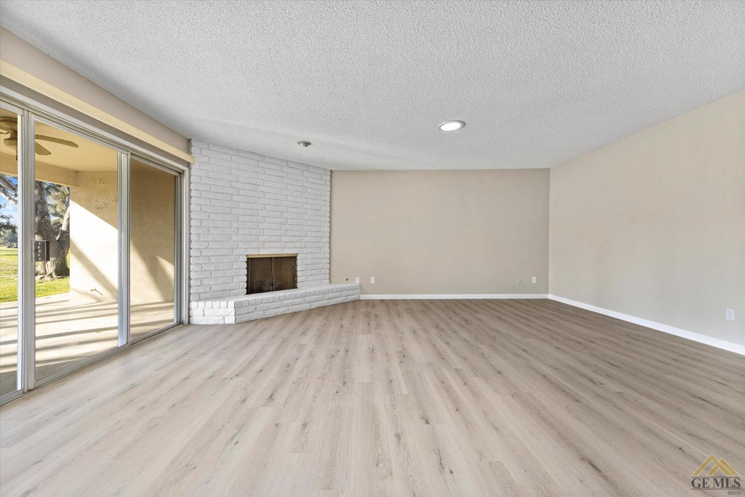 Undisclosed Address Bakersfield, CA 93309 - Photo 7 of 32 a view of empty room with wooden floor and fan