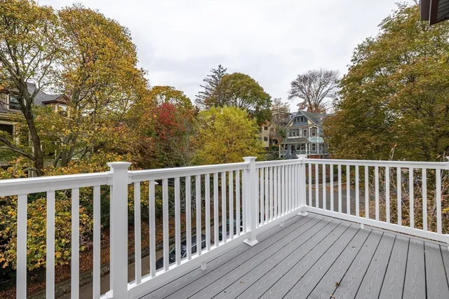 a balcony with wooden floor and fence