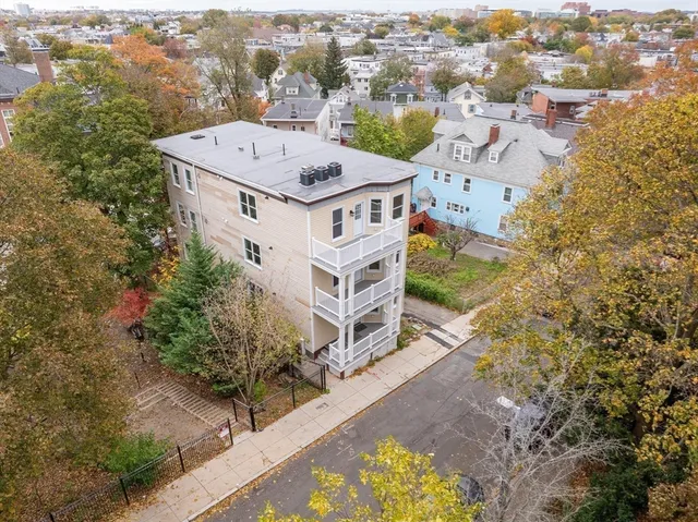 an aerial view of a house with a yard