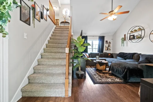 a living room with furniture a fireplace and a chandelier