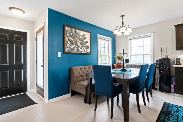 a view of a dining room with furniture and chandelier