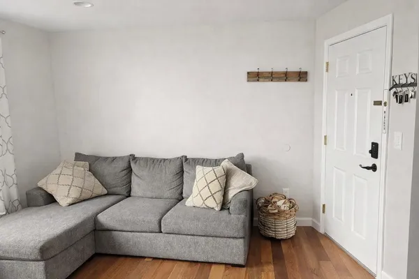 a living room with a couch and a rug