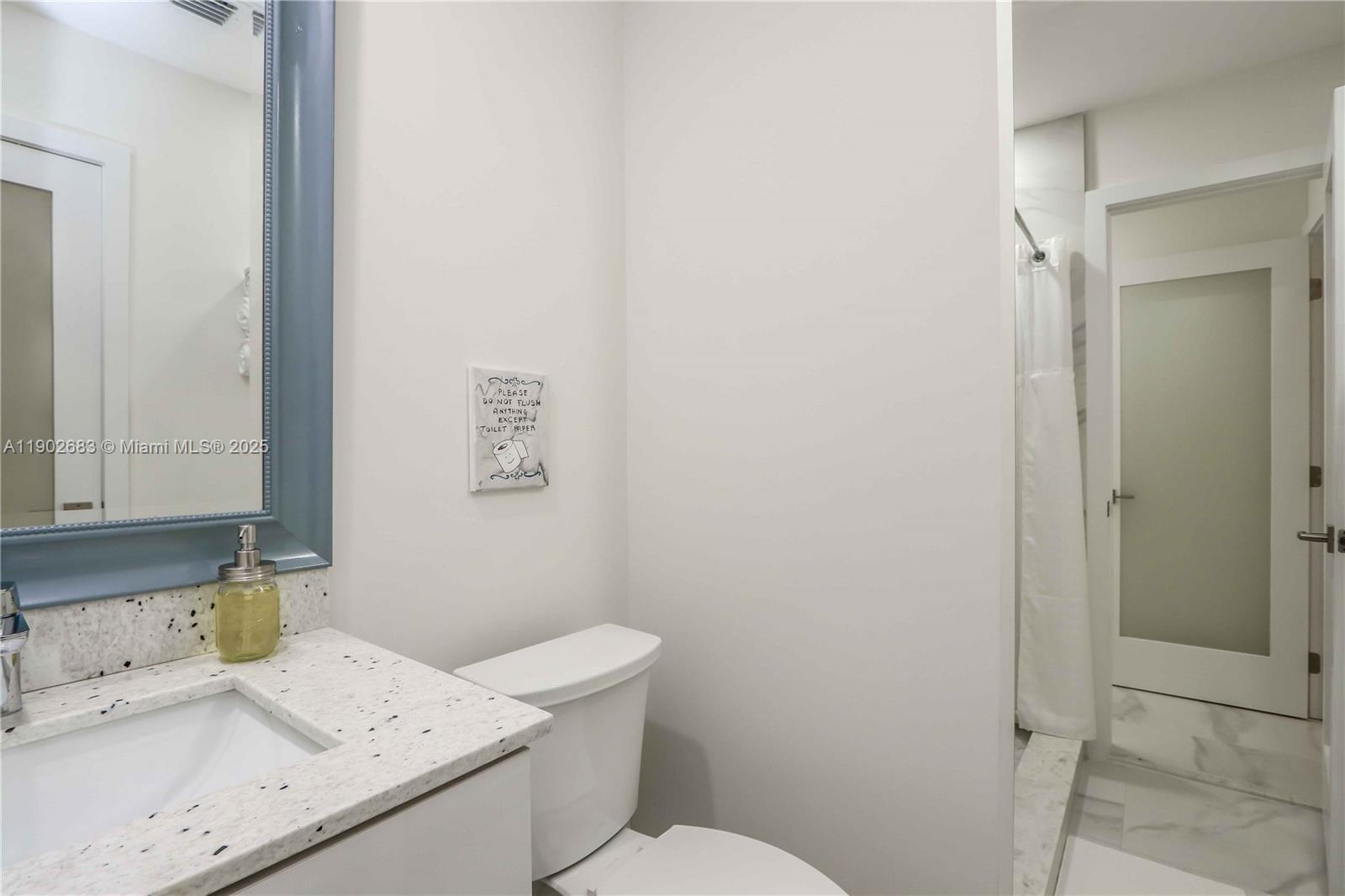 1030 Southwest 10th Avenue Miami, FL 33130 - Photo 13 of 30 a bathroom with a granite countertop sink a toilet and a shower