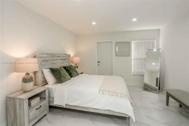 a bedroom with a bed and a view of bathroom