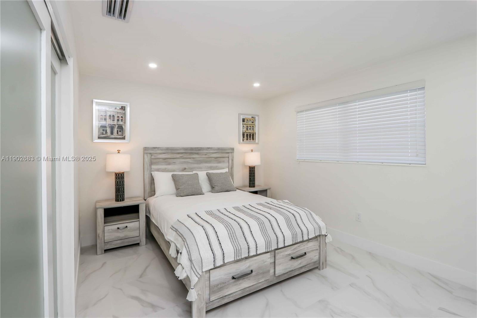 1030 Southwest 10th Avenue Miami, FL 33130 - Photo 21 of 30 a bedroom with a bed and a night stand