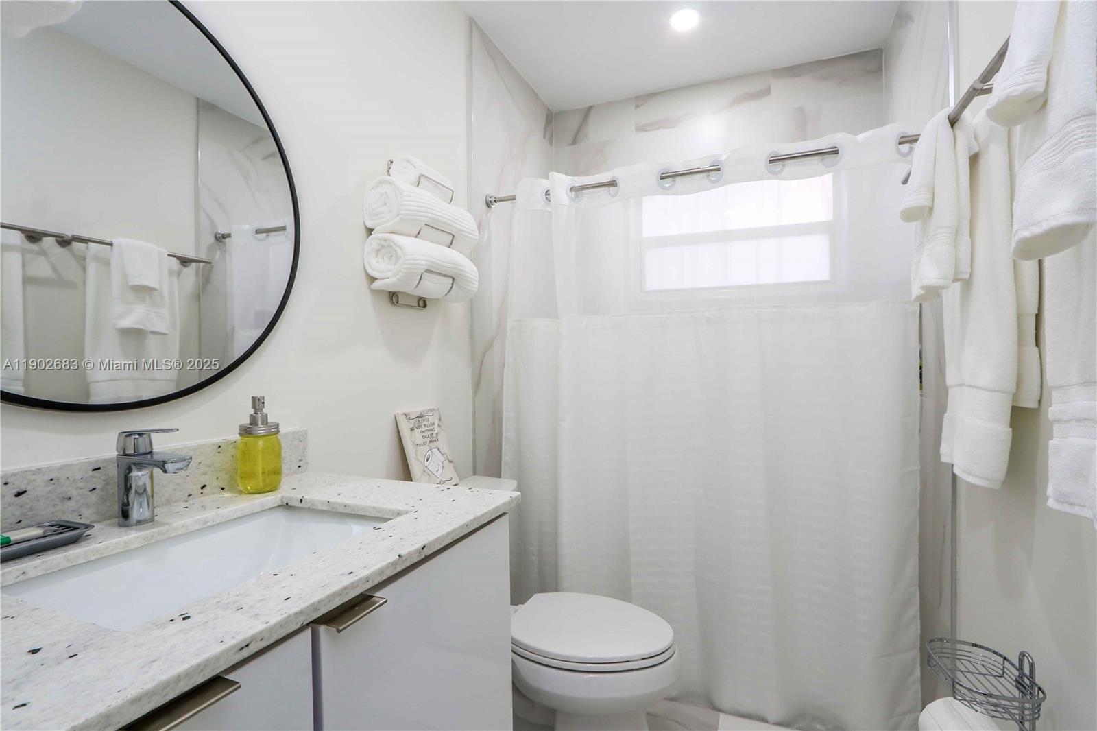 1030 Southwest 10th Avenue Miami, FL 33130 - Photo 23 of 30 a bathroom with a granite countertop sink mirror vanity and toilet