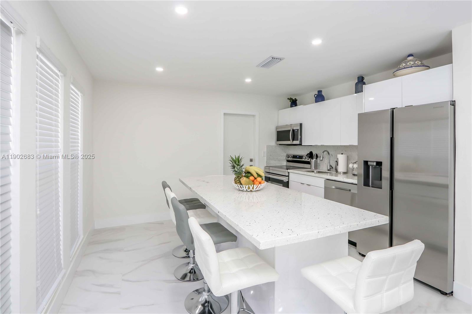 1030 Southwest 10th Avenue Miami, FL 33130 - Photo 25 of 30 a kitchen with stainless steel appliances a refrigerator and a stove top oven