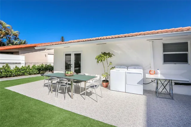 a view of a patio with table and chairs with plants