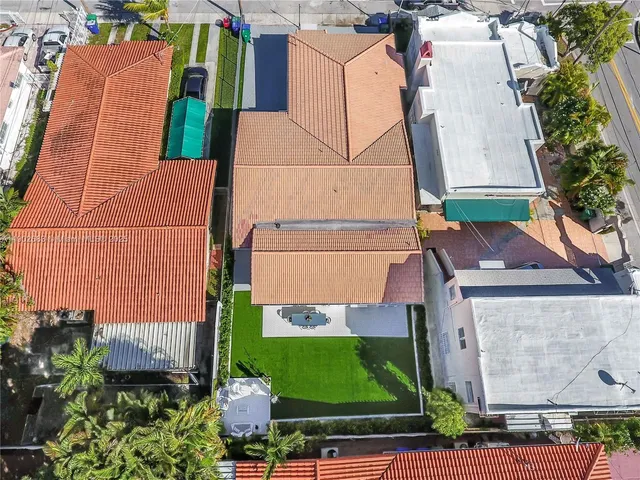 an aerial view of a house with a garden and plants