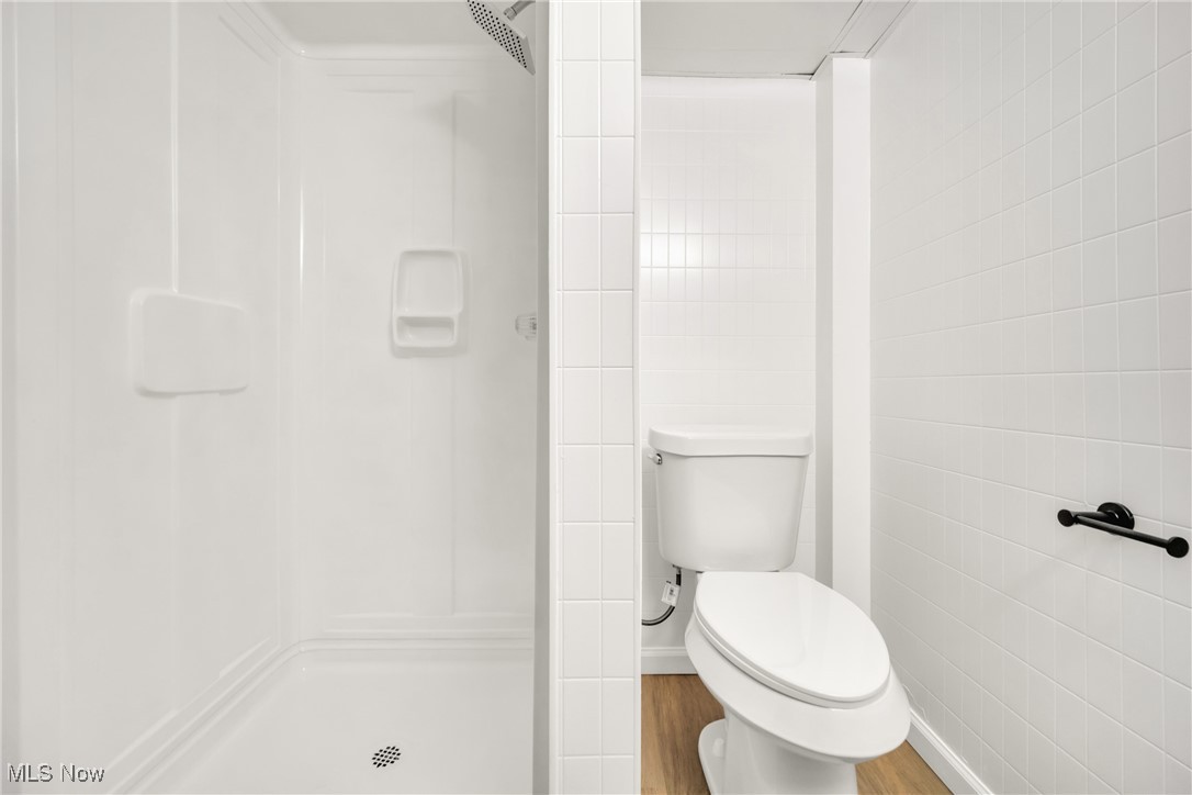 12910 Rockside Road Cleveland, OH 44125 - Photo 27 of 34 Bathroom with hardwood / wood-style floors, a shower, and toilet