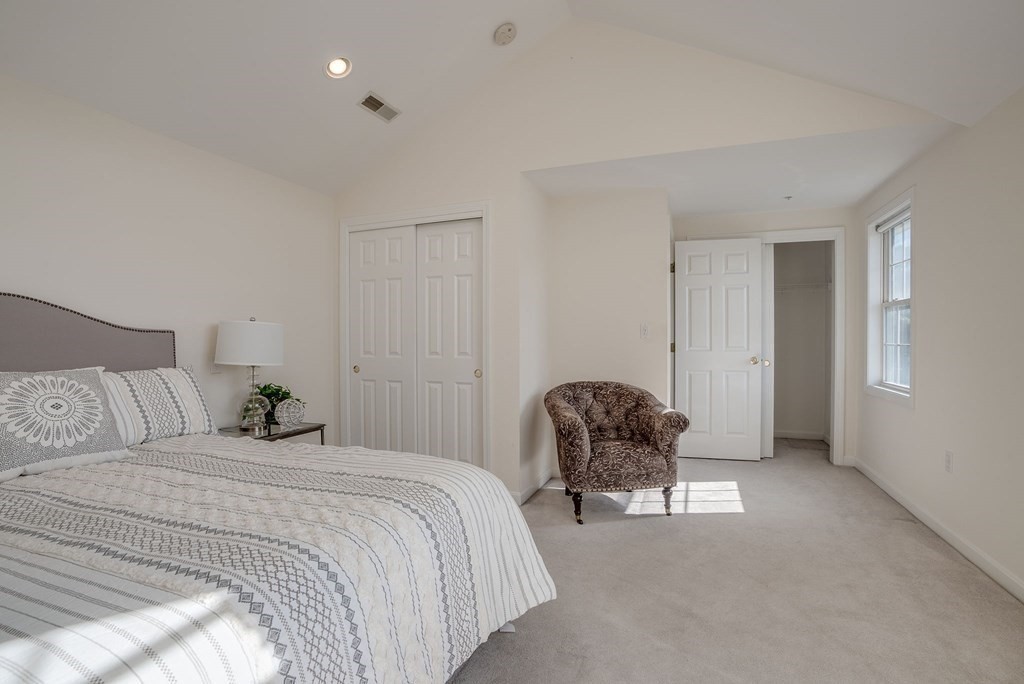 985 Trapelo Road, Unit 22 Waltham, MA 02452 - Photo 13 of 29 a bedroom with a bed and a chair