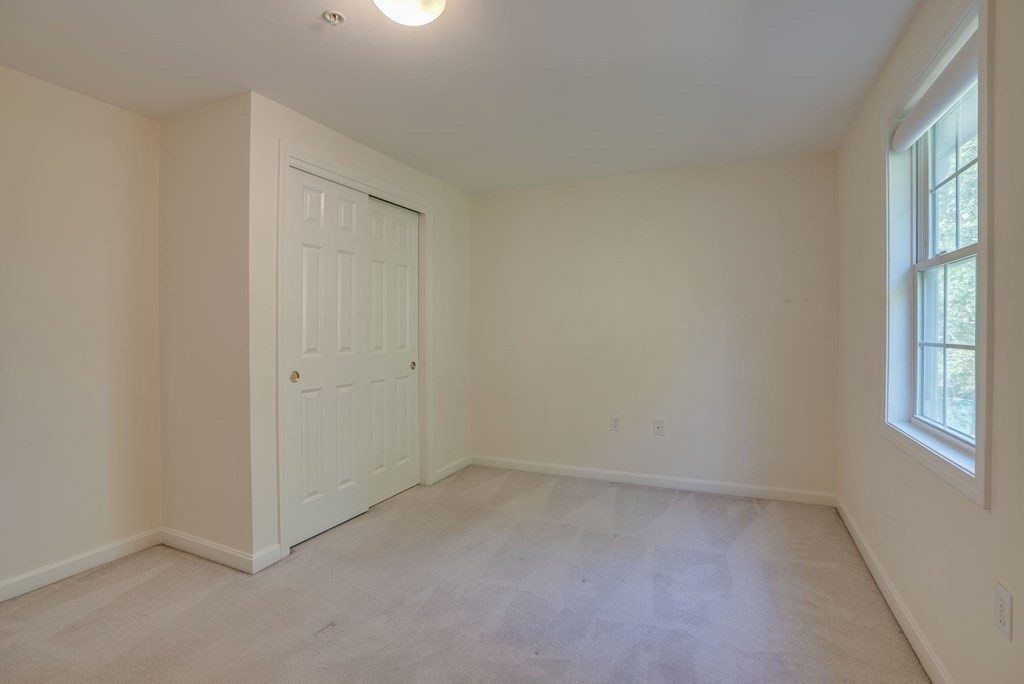 985 Trapelo Road, Unit 22 Waltham, MA 02452 - Photo 14 of 29 an empty room with windows