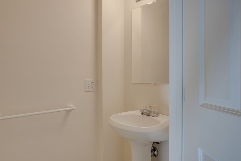985 Trapelo Road, Unit 22 Waltham, MA 02452 - Photo 18 of 29 a bathroom with a sink a toilet and mirror