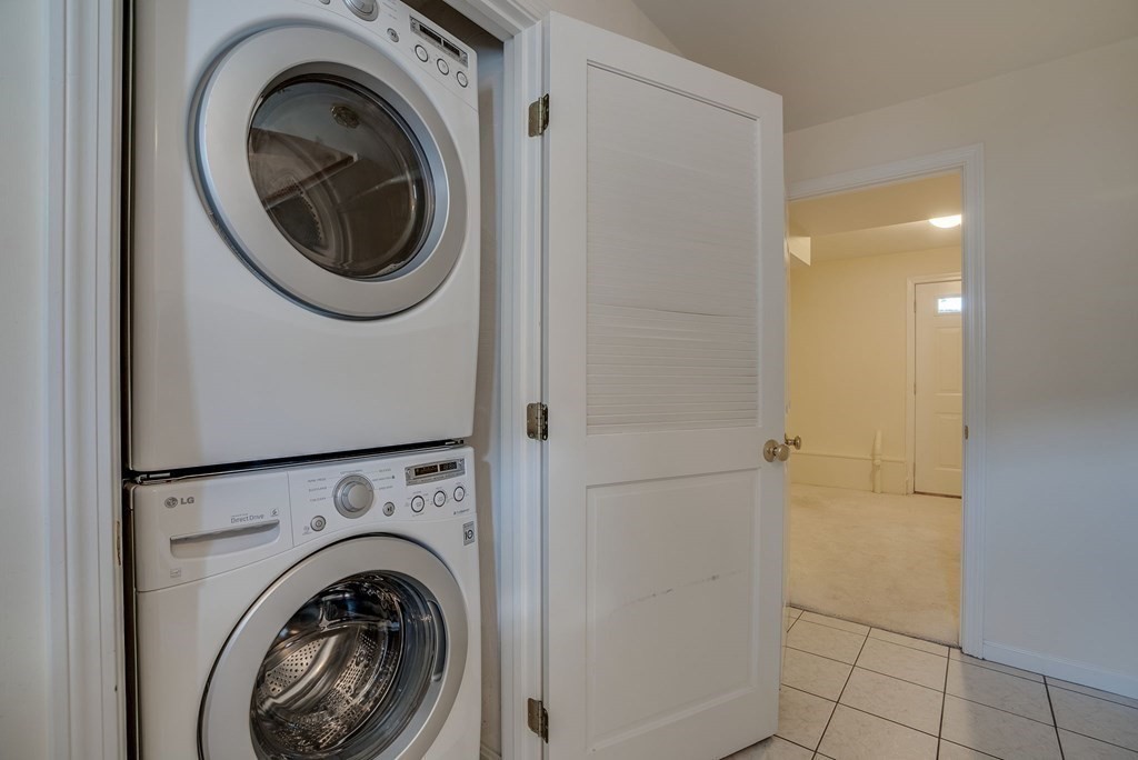 985 Trapelo Road, Unit 22 Waltham, MA 02452 - Photo 19 of 29 a view of a hallway with washer and dryer