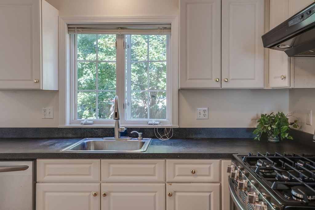 985 Trapelo Road, Unit 22 Waltham, MA 02452 - Photo 2 of 29 a kitchen with stainless steel appliances granite countertop a sink stove and cabinets