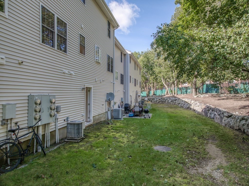 985 Trapelo Road, Unit 22 Waltham, MA 02452 - Photo 23 of 29 a view of backyard of house with green space
