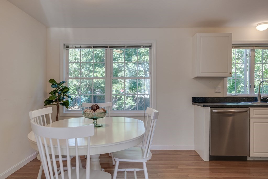 985 Trapelo Road, Unit 22 Waltham, MA 02452 - Photo 4 of 29 a dining room with furniture and wooden floor