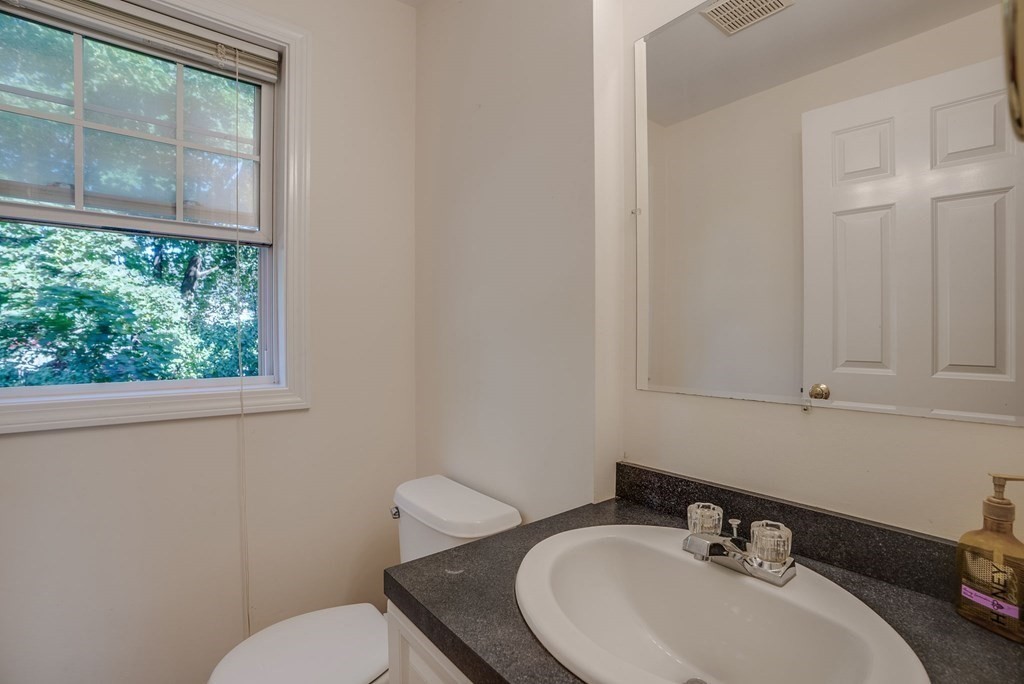985 Trapelo Road, Unit 22 Waltham, MA 02452 - Photo 10 of 29 a bathroom with a sink mirror and toilet