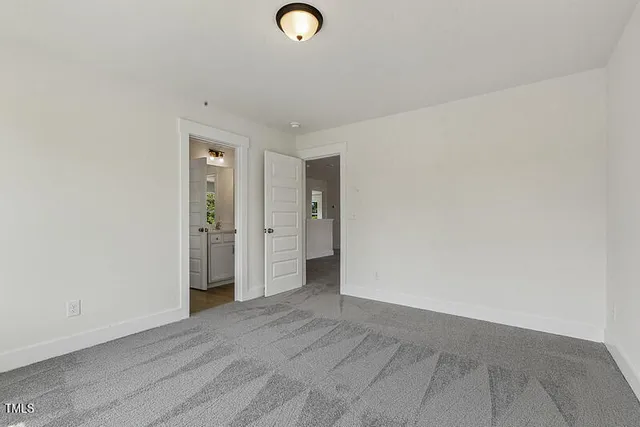 an empty room with windows and entrance