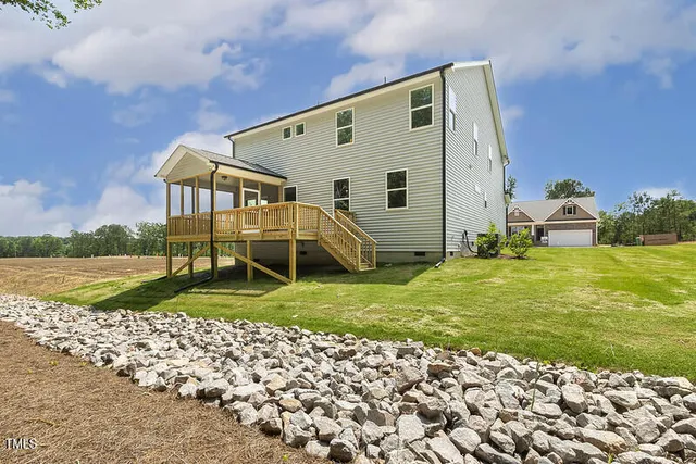 a kitchen with stainless steel appliances granite countertop a sink dishwasher a stove and a refrigerator with wooden floor