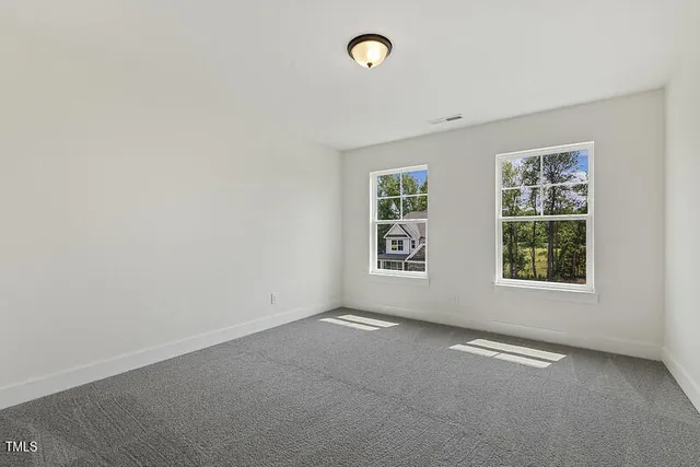 a spacious bathroom with a double vanity sink mirror and shower