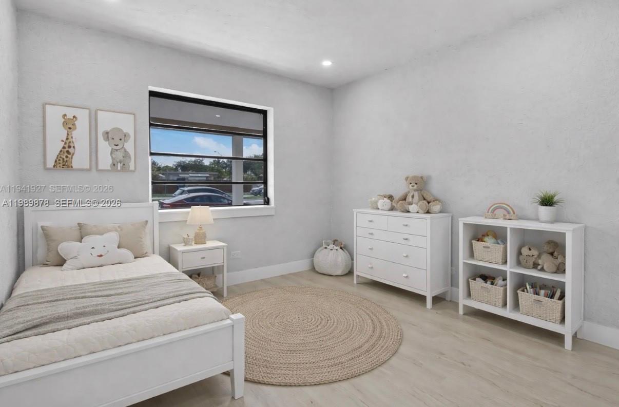 4485 East 8th Avenue Hialeah, FL 33013 - Photo 16 of 26 a bedroom with a large bed and a window
