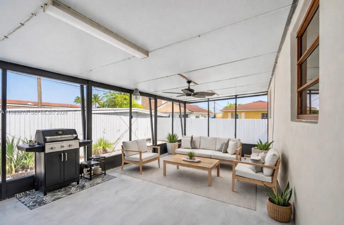 4485 East 8th Avenue Hialeah, FL 33013 - Photo 18 of 26 a living room with furniture and large windows