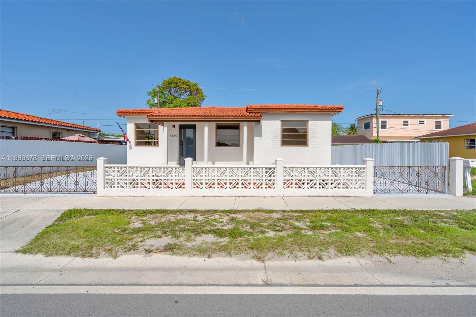 4485 East 8th Avenue Hialeah, FL 33013 - Photo 2 of 26 a view of a house with a yard and deck