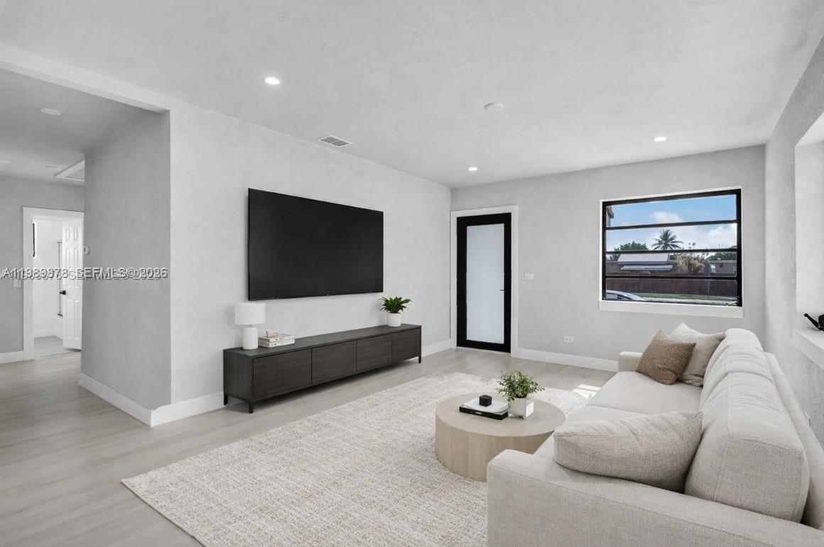4485 East 8th Avenue Hialeah, FL 33013 - Photo 4 of 26 a living room with furniture and a flat screen tv